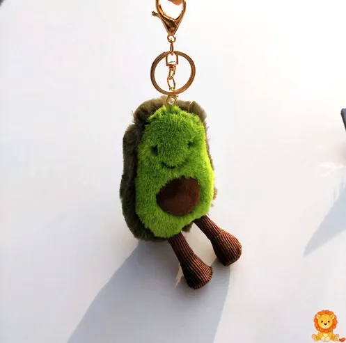 Sevimli bebek avokado peluş anahtarlık, yeşil ve kahverengi renklerde, yumuşak dokulu ve anahtarlara takılı halde. - View 3