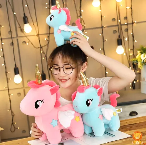 Cuddly blue unicorn plush with a shimmering golden horn, soft fur, and embroidered details, perfect for snuggling and imaginative play. - View 4