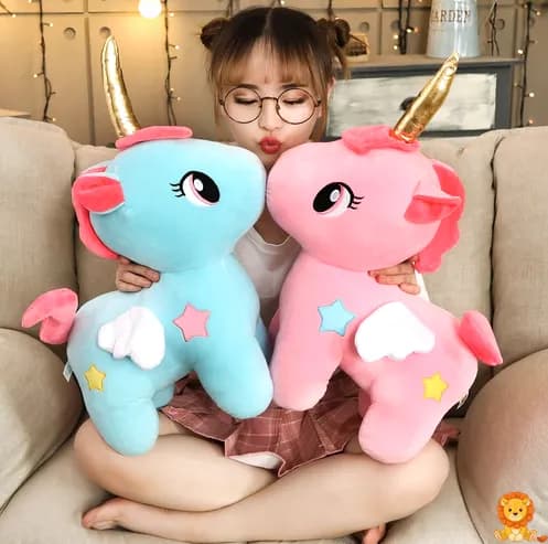 Cuddly blue unicorn plush with a shimmering golden horn, soft fur, and embroidered details, perfect for snuggling and imaginative play. - View 2