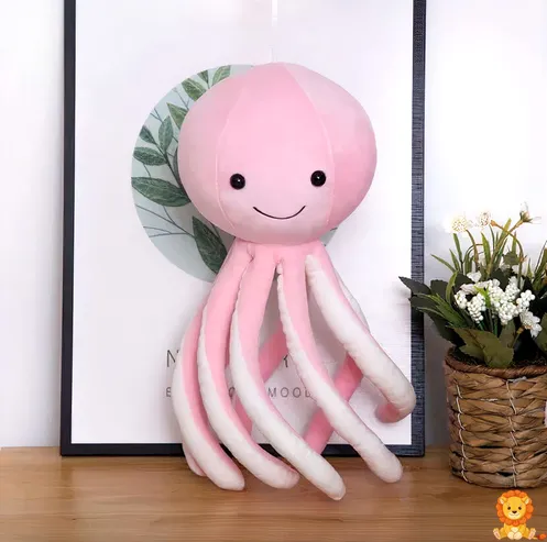 Sevimli pembe peluş ahtapot, gülümseyen yüzü ve kıvrımlı kollarıyla, yumuşak ve sarılabilir bir oyuncak. - View 3